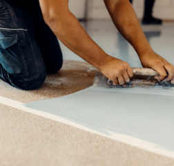 Man adding epoxy on floor